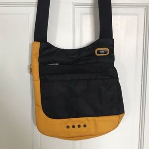 Tumi T Tech McKenna black and yellow crossbody bag.